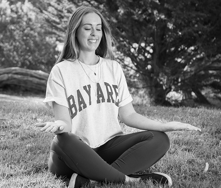 Woman at peace doing yoga in the park.